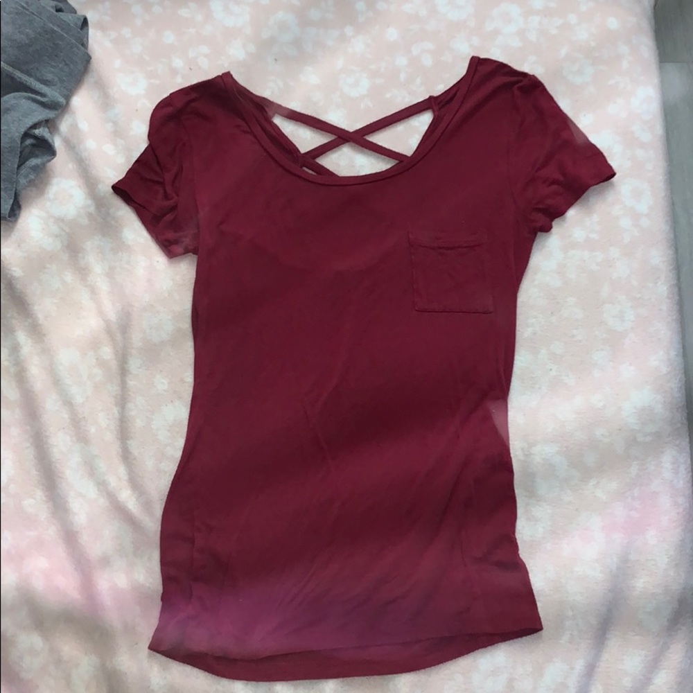 red shirt, crosses on back. perfect condition